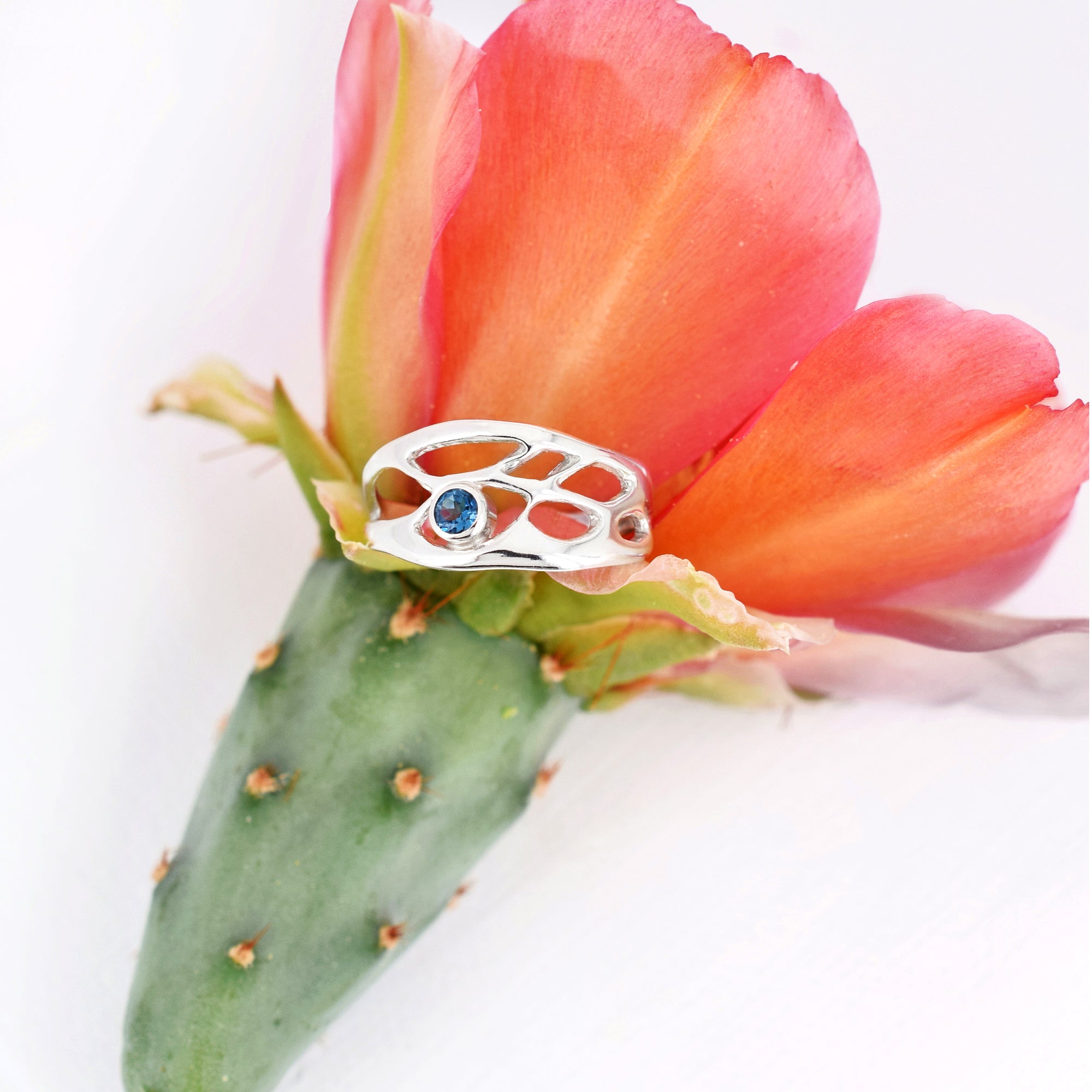 dainty silver botanical ring with birthstone on white background