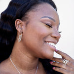 silver organic cactus hook earrings on smiling woman