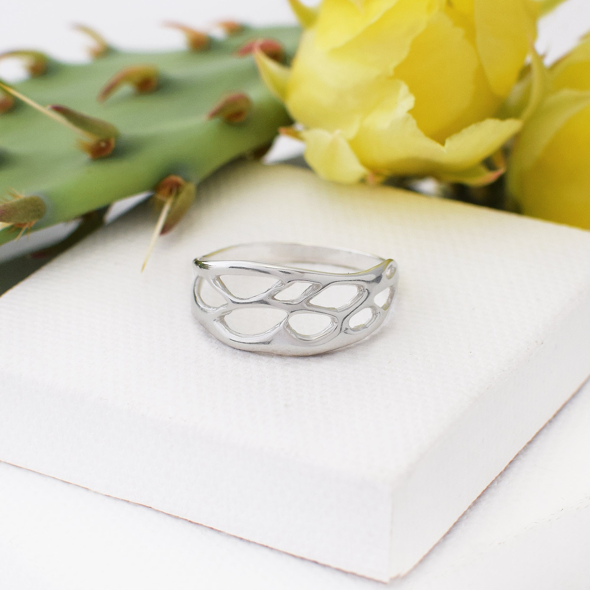 silver unique ring on white background with cactus accent