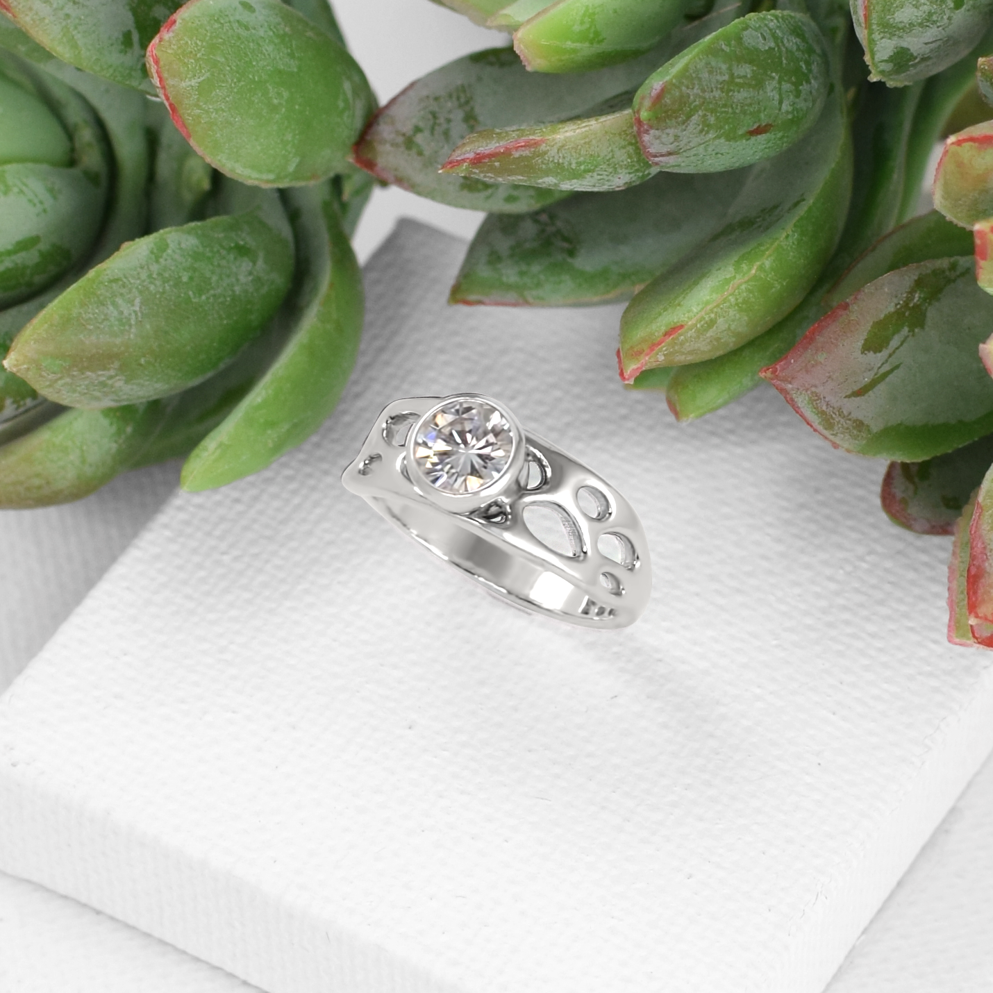 silver non-traditional engagement ring on white background with cactus
