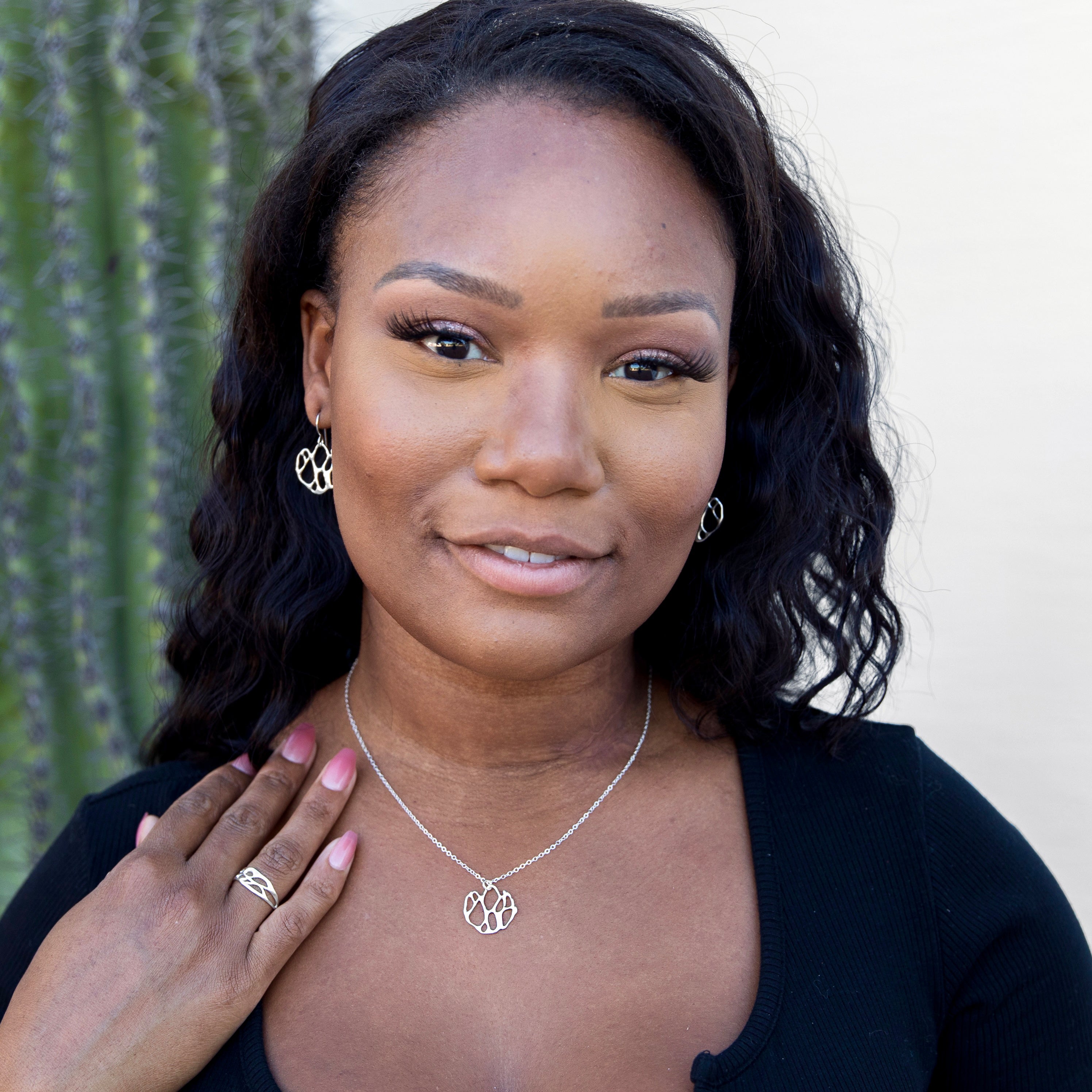 silver cactus earrings and necklace on woman