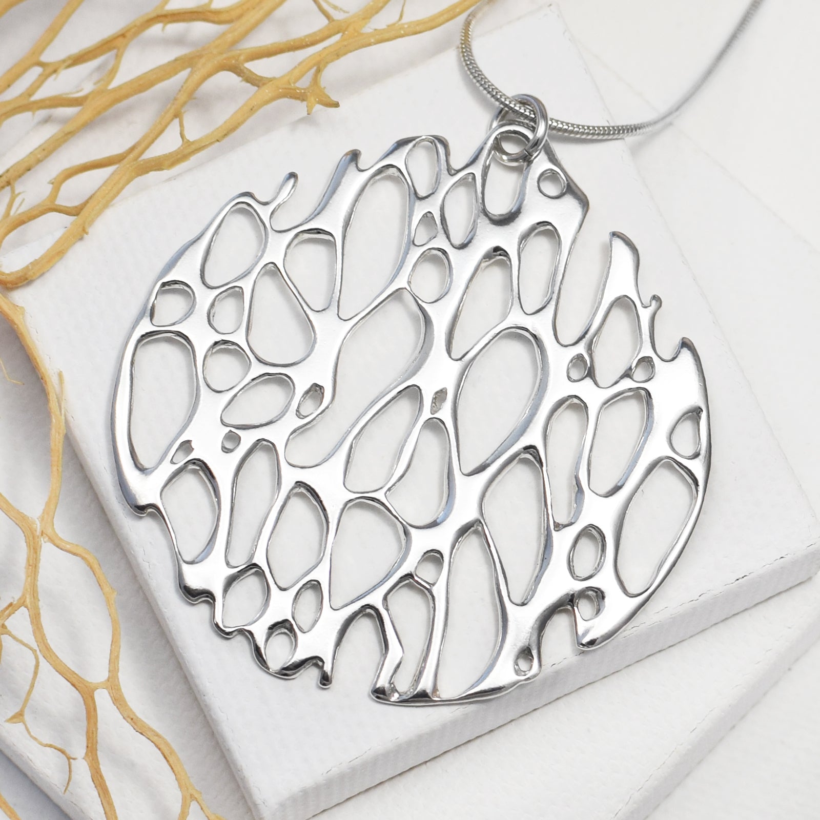 organic desert cactus skeleton necklace on white background