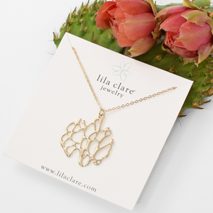 gold cactus necklace on white card with prickly pear cactus