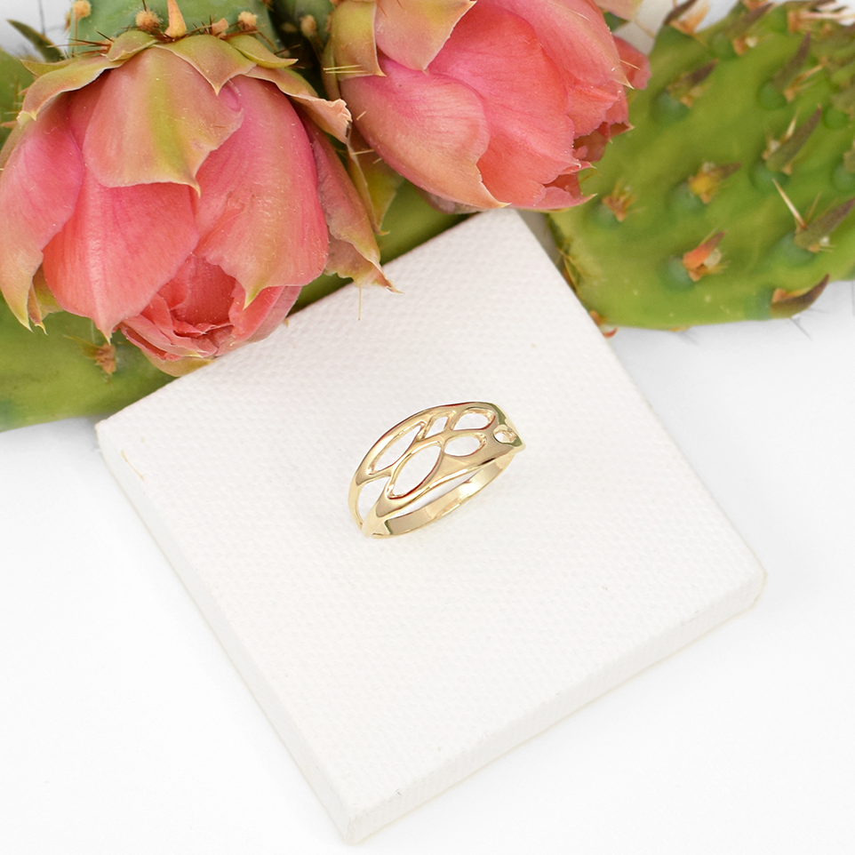 gold botanical wedding ring on white background with prickly pear cactus
