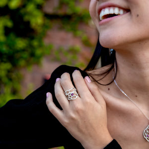 botanical engagement ring with gem on smiling woman's hand